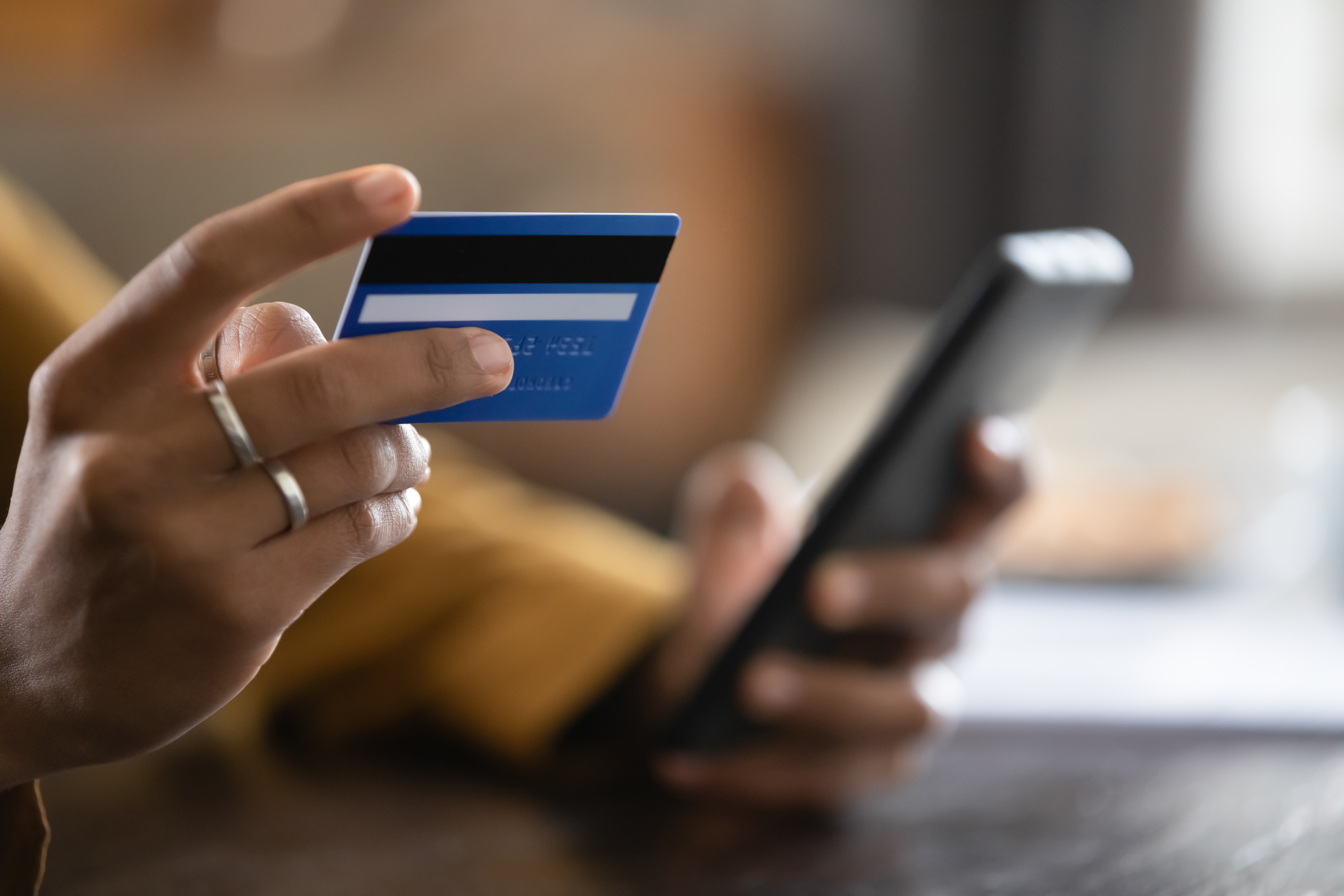 Primer plano de mujer comprando con tarjeta de crédito y smartphone